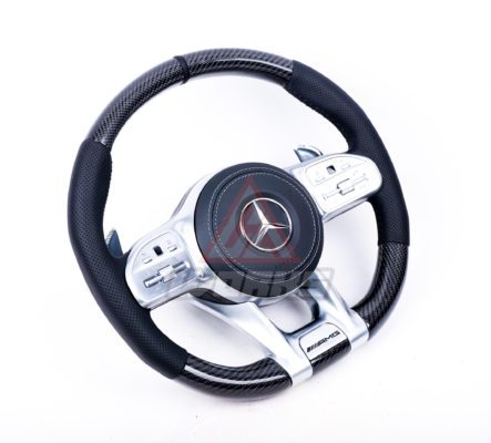 A 2019+ generation retrofit amg steering wheel, customized in gloss black carbon fiber, black perforated leather side grips, black nappa leather airbag and satin silver equipment.